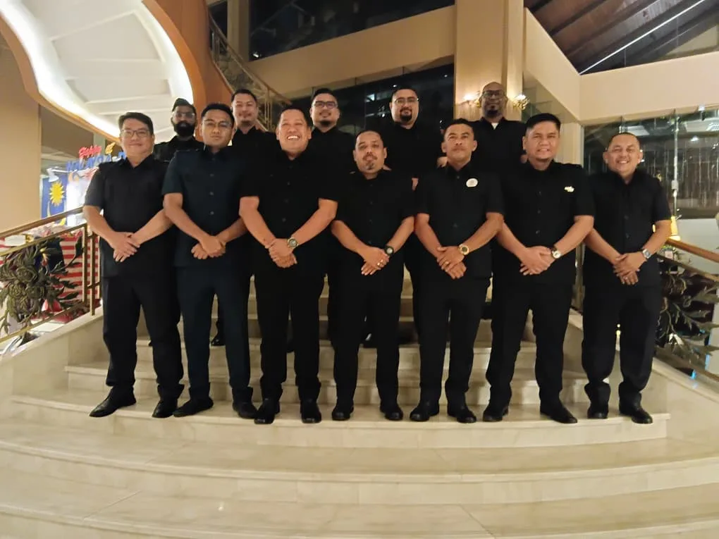 Fourteen uniformed JeyRey drivers on hotel grand staircase
