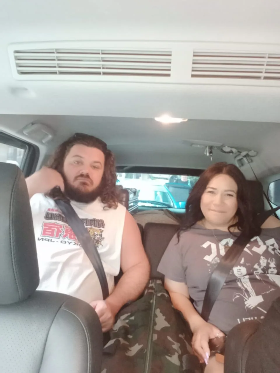 Couple relaxing in van during outstation trip