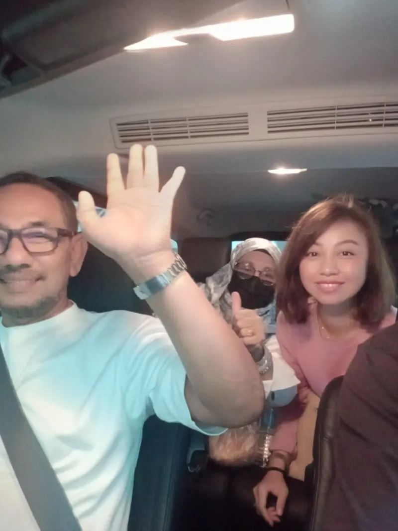 Smiling couple in back seat during comfortable city transfer