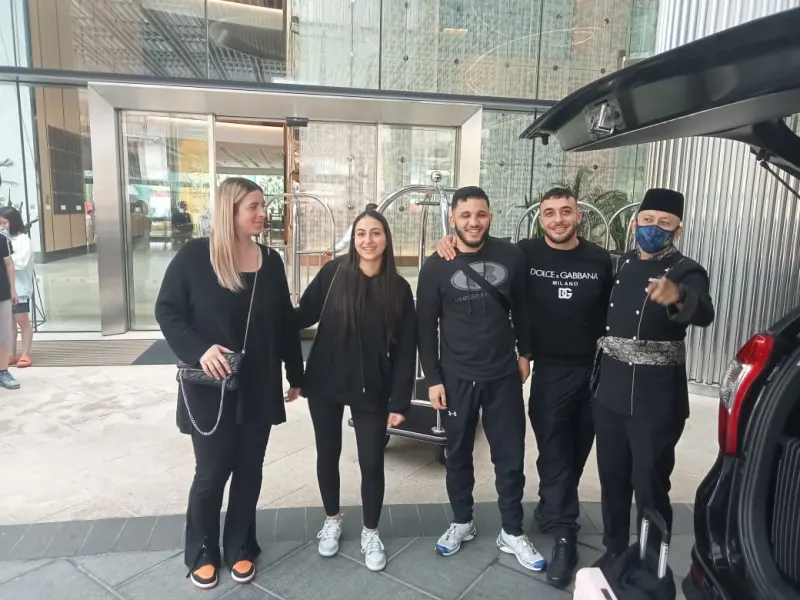 International guests at luxury hotel entrance after JeyRey airport transfer