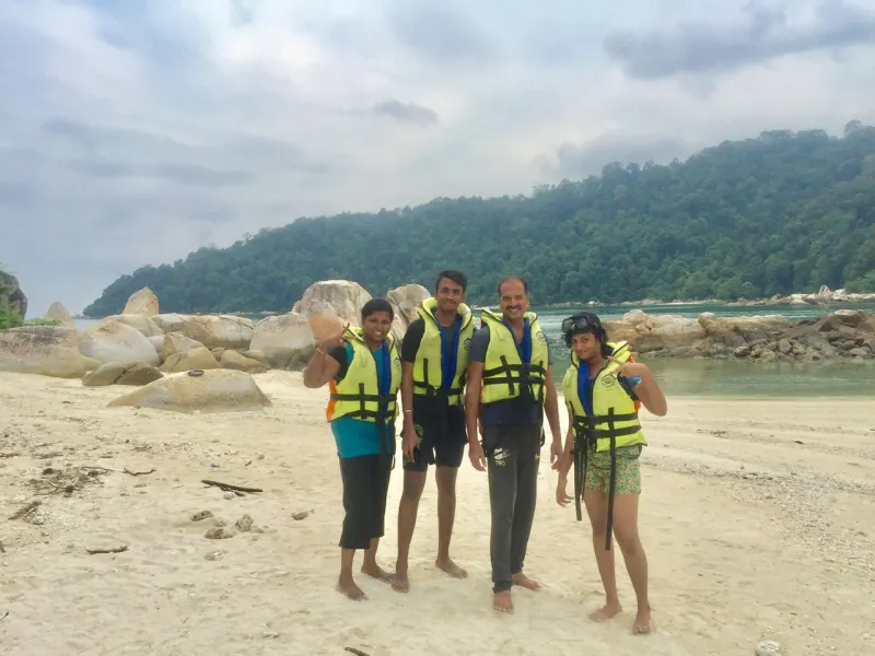 Group photo on pristine tropical beach during island day trip