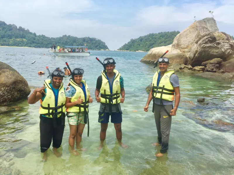 Happy snorkeling group at crystal clear island waters in Malaysia