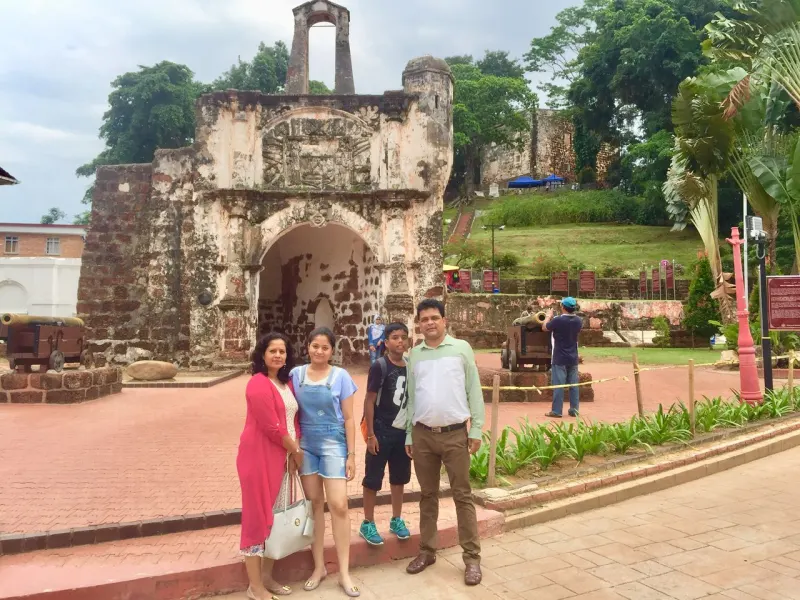 Happy family posing at A Famosa fortress in Melaka on a JeyRey day trip